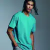 Man wearing a turquoise Anthem heavyweight t-shirt, front view.