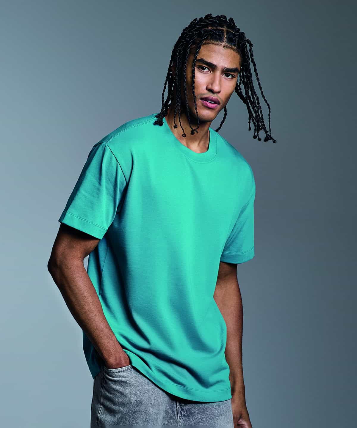 Man wearing a turquoise Anthem heavyweight t-shirt, front view.