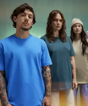 Group of three models wearing colourful embroidered T-shirts for casual fashion.