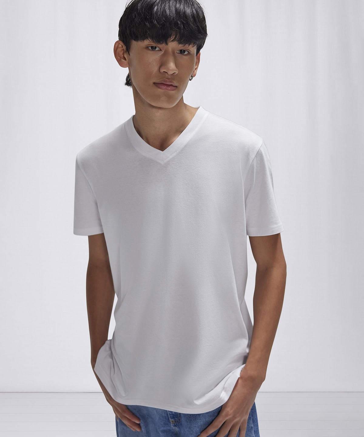 White V-neck T-shirt with embroidery and printing details.