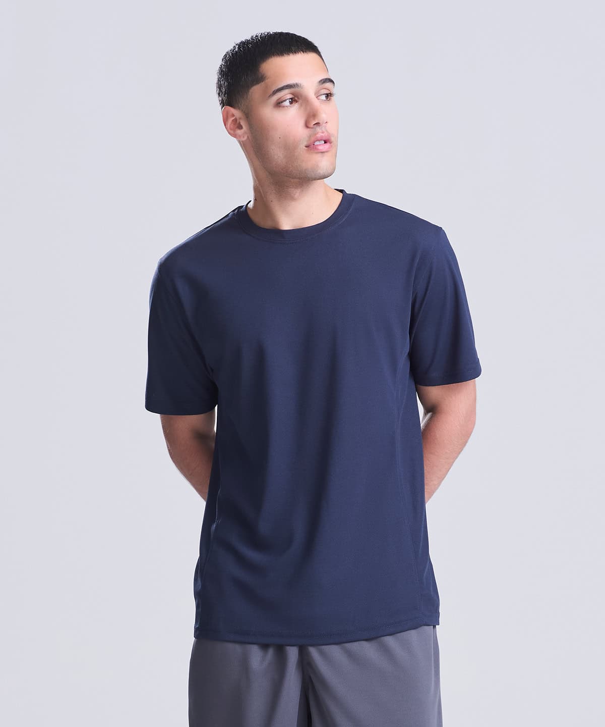 Man wearing a navy blue performance T-shirt for sports and activewear.