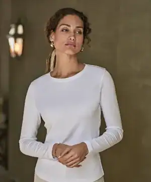Elegant white long sleeve interlock tee for women, perfect for casual or workwear. Custom embroidery.