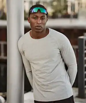 Man wearing Long Sleeve CoolDry T-shirt with sunglasses outdoors.