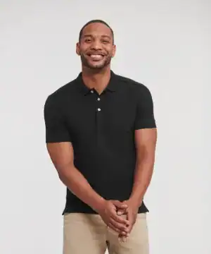 Man wearing a black stretch polo shirt, casual and comfortable fit.