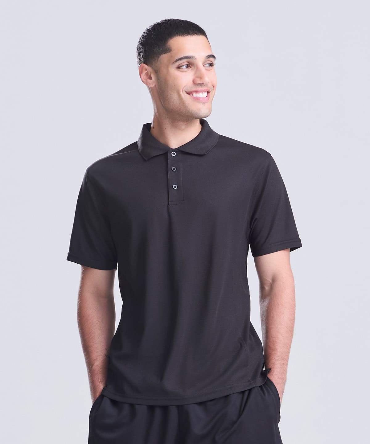 Man wearing a black performance polo shirt, ideal for sports and casual wear.