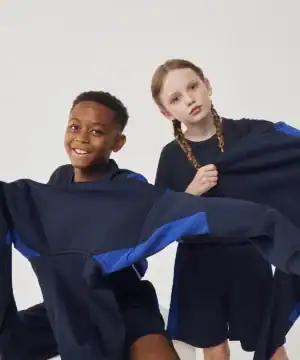 Image showing kids wearing navy blue hoodies and sportswear with printed branding.