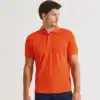 Man wearing bright orange polo shirt with embroidery, casual style.