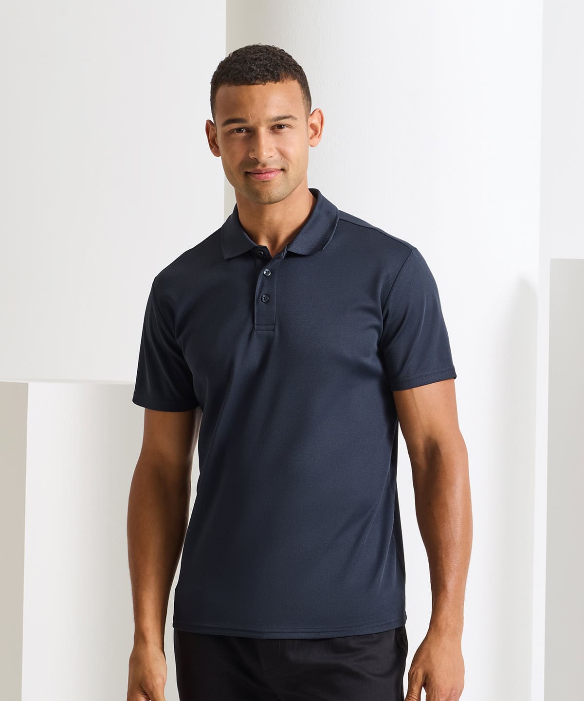 Man wearing navy blue spun dyed recycled polo shirt for sustainable fashion.