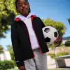 Bright kids' softshell jacket with vibrant red accents, perfect for outdoor activities.