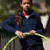 Girl wearing navy half-zip microfleece jacket outdoors, suitable for kids' casual wear.